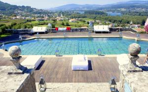 a large swimming pool with a view of the water at Boega Hotel in Vila Nova de Cerveira