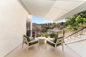 a balcony with a table and chairs and a view at Katarina in Rabac