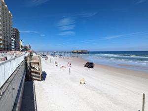 a view of a beach with people and the ocean at The Pointe at Daytona Beach Shores in Daytona Beach Shores