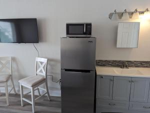 a kitchen with a microwave on top of a refrigerator at The Pointe at Daytona Beach Shores in Daytona Beach Shores