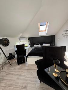 a bedroom with a bed and a couch and a table at Willa La mer-Balia z jacuzzi, sauna ,klimatyzacja ,rowery in Ustka