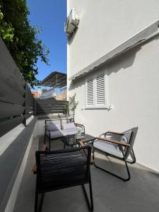 a group of chairs and tables on a balcony at Apartmani Mia in Bibinje