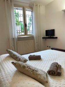 a bedroom with a bed with two stuffed animals on it at Casa Matilde in Ferrara