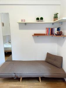 a bed in a room with a wall with shelves at Casa Matilde in Ferrara