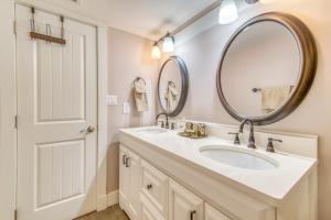 a bathroom with a sink and a mirror at Beach House Condominiums B101 - Beachfront with Pool, WiFi, & Beach Service in Destin