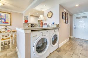 a laundry room with a washer and dryer at Beach House Condominiums B101 - Beachfront with Pool, WiFi, & Beach Service in Destin