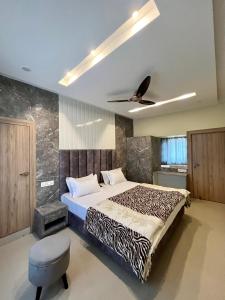 a bedroom with a bed and a ceiling fan at Shomaan boutique hotel in Sundarnagar