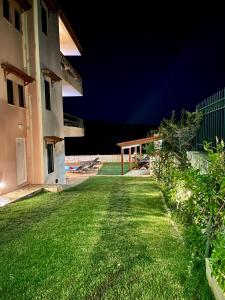 a yard of a house at night with a patio at Olive Villa in Xirokámbion