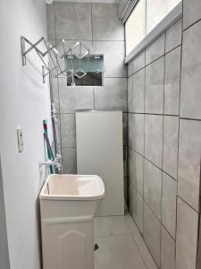 y baño con aseo blanco y lavamanos. en Apartamento em Florianópolis Próximo ao Aeroporto en Florianópolis