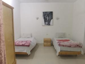 a room with two beds and a picture of an elephant at Luxor family in Luxor +17 photos