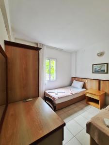 a bedroom with a bed and a table in it at Fora Apart Otel Cesme in Çeşme +49 photos