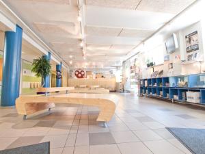a lobby of a store with a bench in the middle at Eurohostel in Helsinki