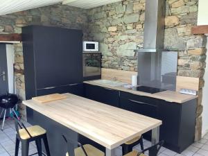 a kitchen with a wooden counter and a counter top at Le petit Four Neuf in Lézardrieux