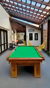 a pool table in the middle of a room at Beach Guest House - GMT in Rio de Janeiro