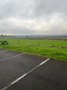 a picnic table sitting on the side of a road at The Dog and Partridge in Langsett