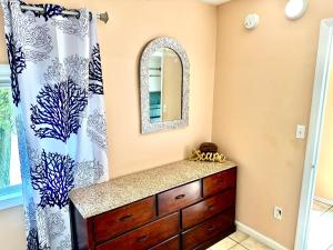 a bathroom with a sink and a mirror at Bill's Apartments in Ocean City
