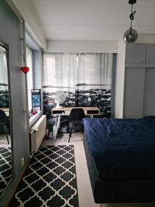 a bedroom with a bed and a desk with a computer at Lakeland Apartments in Rovaniemi