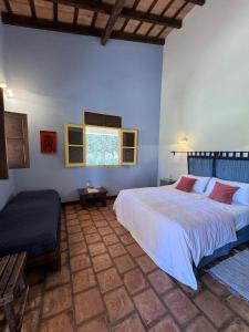 a bedroom with a large bed and a window at La Vaca Tranquila in San Carlos