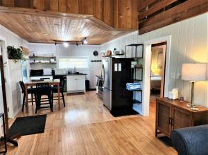a kitchen and dining room with a black refrigerator at Steps to Beach-Hot Tub-Fireplace-Northern Original in Traverse City