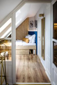 a small bedroom with a bed in a attic at Nook with a view - Quelle in Győr