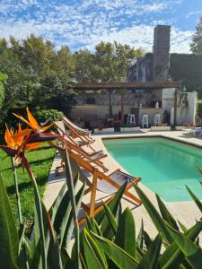 a pool with lounge chairs and a resort at Posada El Capullo in Colonia del Sacramento