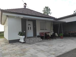 a house with a patio and a white door at Vikendica Ninic in Laktaši