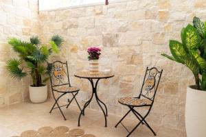 two chairs and a table with a cake on it at Stanze di Puglia in Sannicandro di Bari