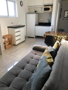 a person laying on a couch in a living room at Rua Dr. Diogo de Faria, 671 apto 22 in Sao Paulo