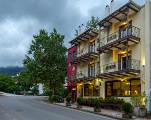 a building with balconies on the side of a street at Xenonas Sta Tzakia in Karpenisi