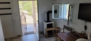 a living room with a door to a balcony with a television at PERFECT NEST at Sunset Beach in Vela Luka