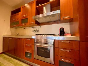a kitchen with wooden cabinets and a stainless steel oven at Dadu 150 in Bari