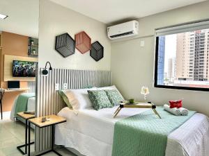 a small bedroom with a bed and a window at (108) Studio moderno - Perto da Praia in São Luís