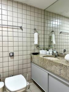 a bathroom with a toilet and a sink at (108) Studio moderno - Perto da Praia in São Luís +32 photos