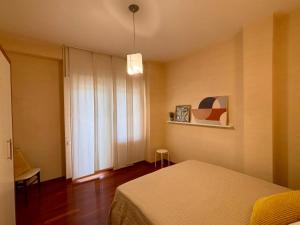 a bedroom with a bed and a large window at Dadu 150 in Bari