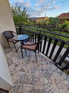 a patio with two chairs and a table on a balcony at Sobe Lejla in Vipava