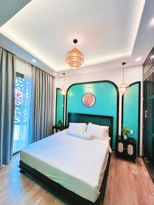 a bedroom with a large bed with a large window at Lamy's House Cần Thơ in Can Tho