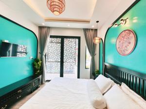 a bedroom with a large bed and a window at Lamy's House Cần Thơ in Can Tho