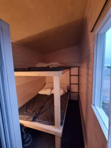 a bunk bed in a tiny house at Kirjurin Leirintä in Pori +2 photos