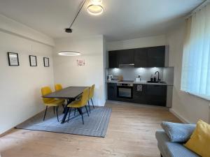 a kitchen and dining room with a table and chairs at Das Mühlbach in Rechnitz