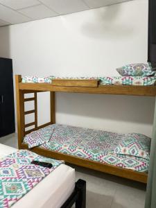 two bunk beds in a room with another bed at Cabañas Ypaos in Coveñas