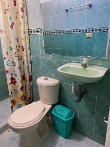 a bathroom with a toilet and a sink at Cabañas Ypaos in Coveñas