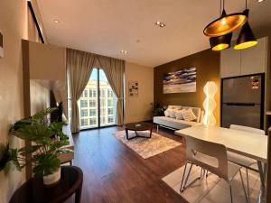 a living room with a couch and a table at L Homestay Riverson Soho KK City Very Near Imago in Kota Kinabalu