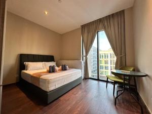 a bedroom with a bed and a table and a window at L Homestay Riverson Soho KK City Very Near Imago in Kota Kinabalu +207 photos