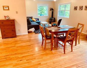 a living room with a wooden table and chairs at Blue Cedar Suite in Tofino
