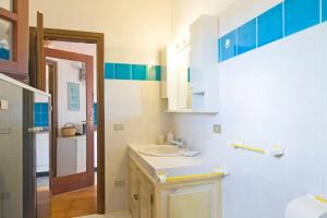 a bathroom with a sink and a sink at By the sea with amazing view in Capo Coda Cavallo