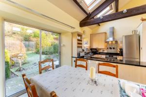 uma cozinha com uma mesa e uma grande janela em Grey Crag Barn em Grasmere