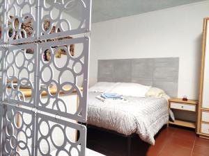 a bedroom with a bed and a metal gate with a bed at La Casina di Enea in Cascia