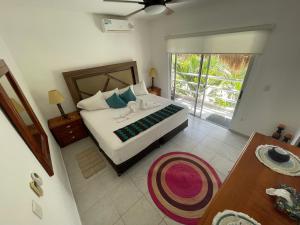 sypialnia z łóżkiem i przesuwnymi szklanymi drzwiami w obiekcie Home's Jungle Puerto Morelos Cancun 20 Minutes from the Airport w mieście Cancún