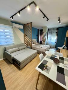 a living room with a couch and a table at Blue Luxury Apartment in Golem