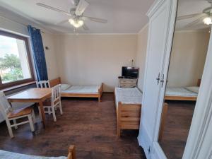 a room with a table and a dining room at Hostel Rumiankowy Airport Hostel in Wrocław